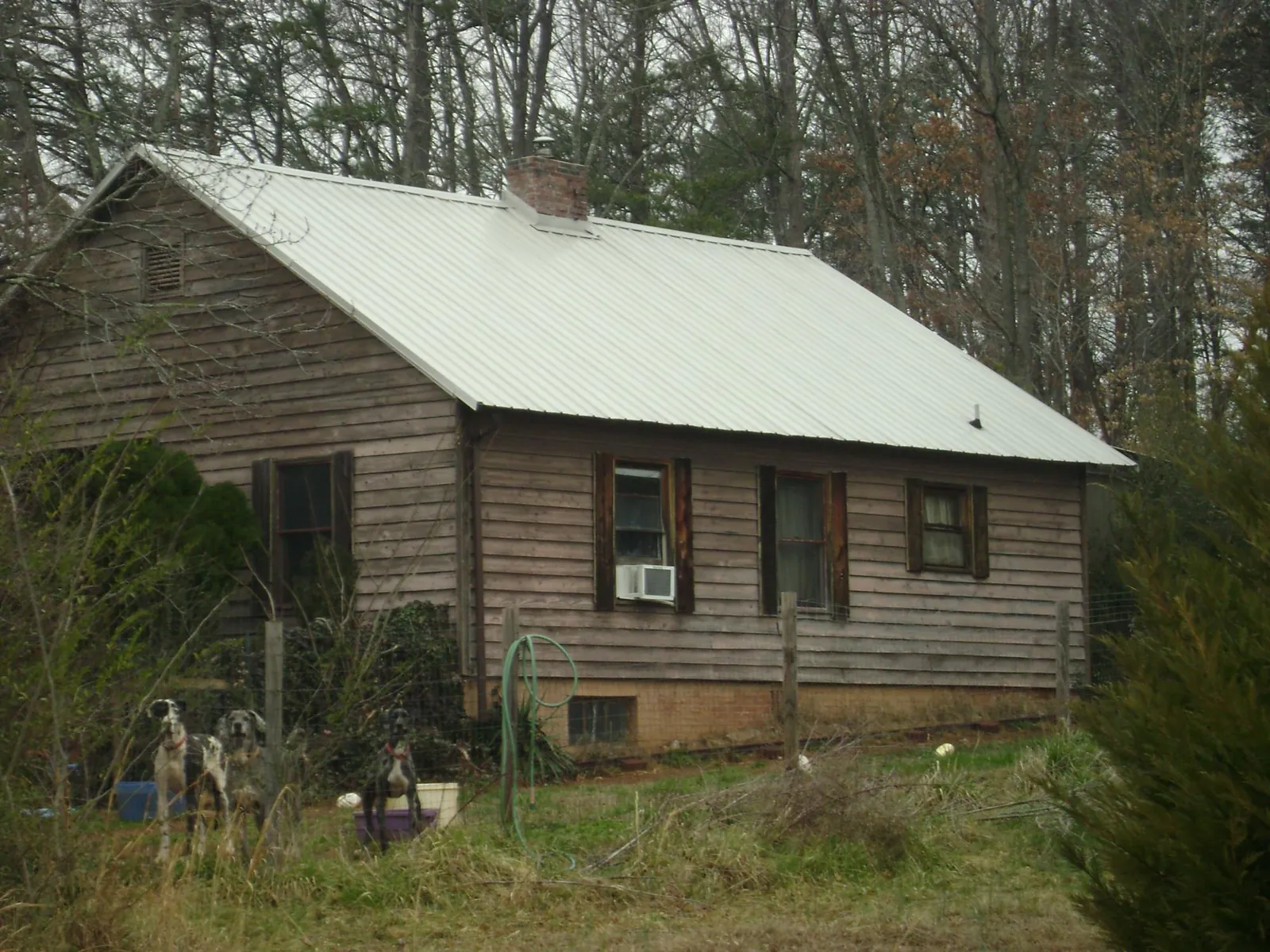 White metal roof on an old wood sided farmhouse, from a Metal Roof Installation job in De Witt